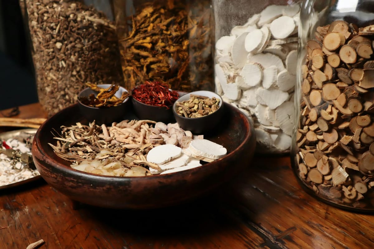 assorted dried adaptogen herbs and roots in bowls