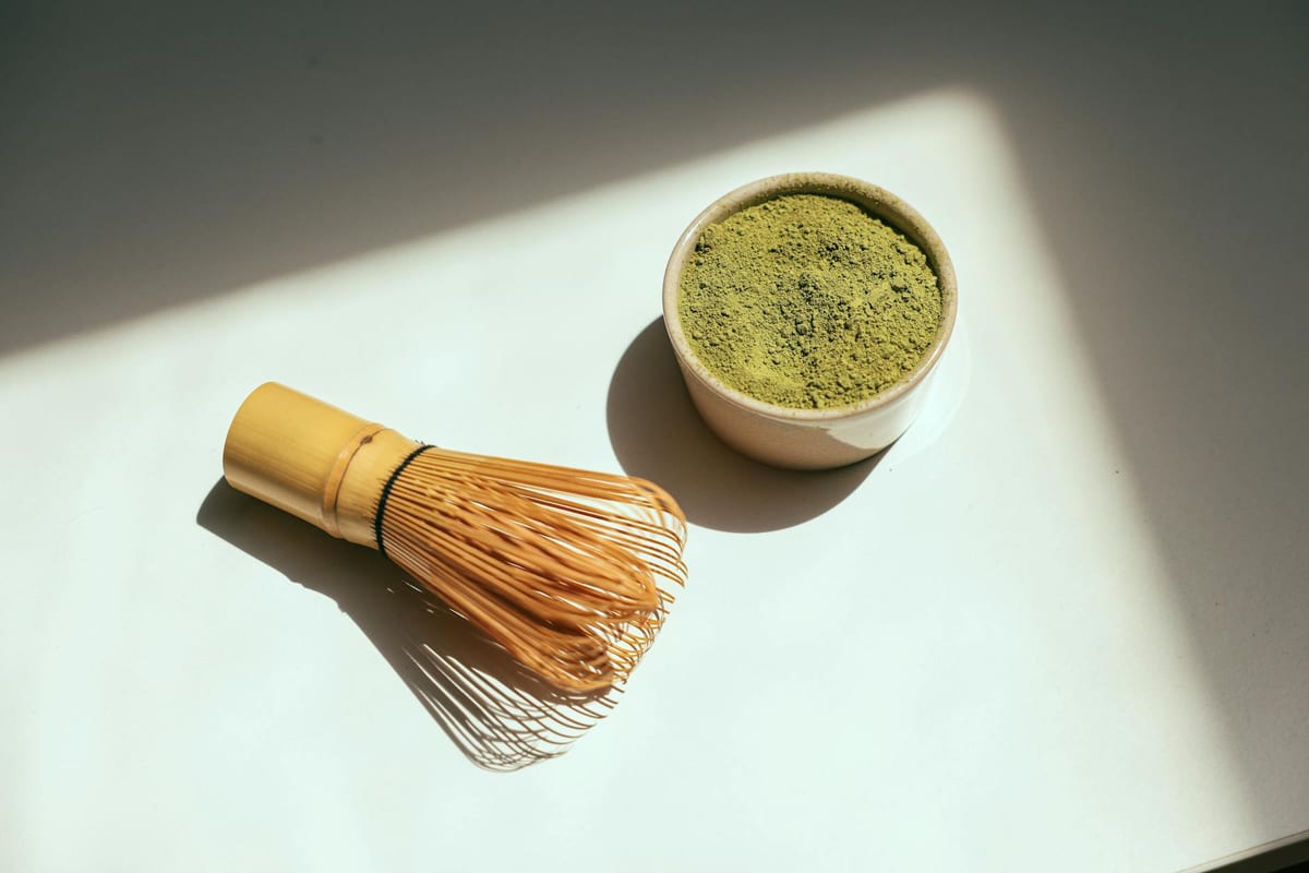 matcha green tea powder with bamboo whisk