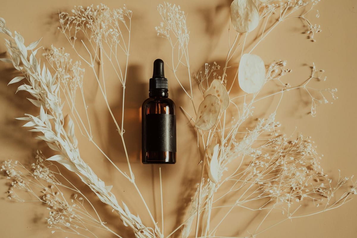 herbal tincture amber dropper bottle with dried herbs